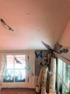 Birch logs and butterflies in the corner of the landing space